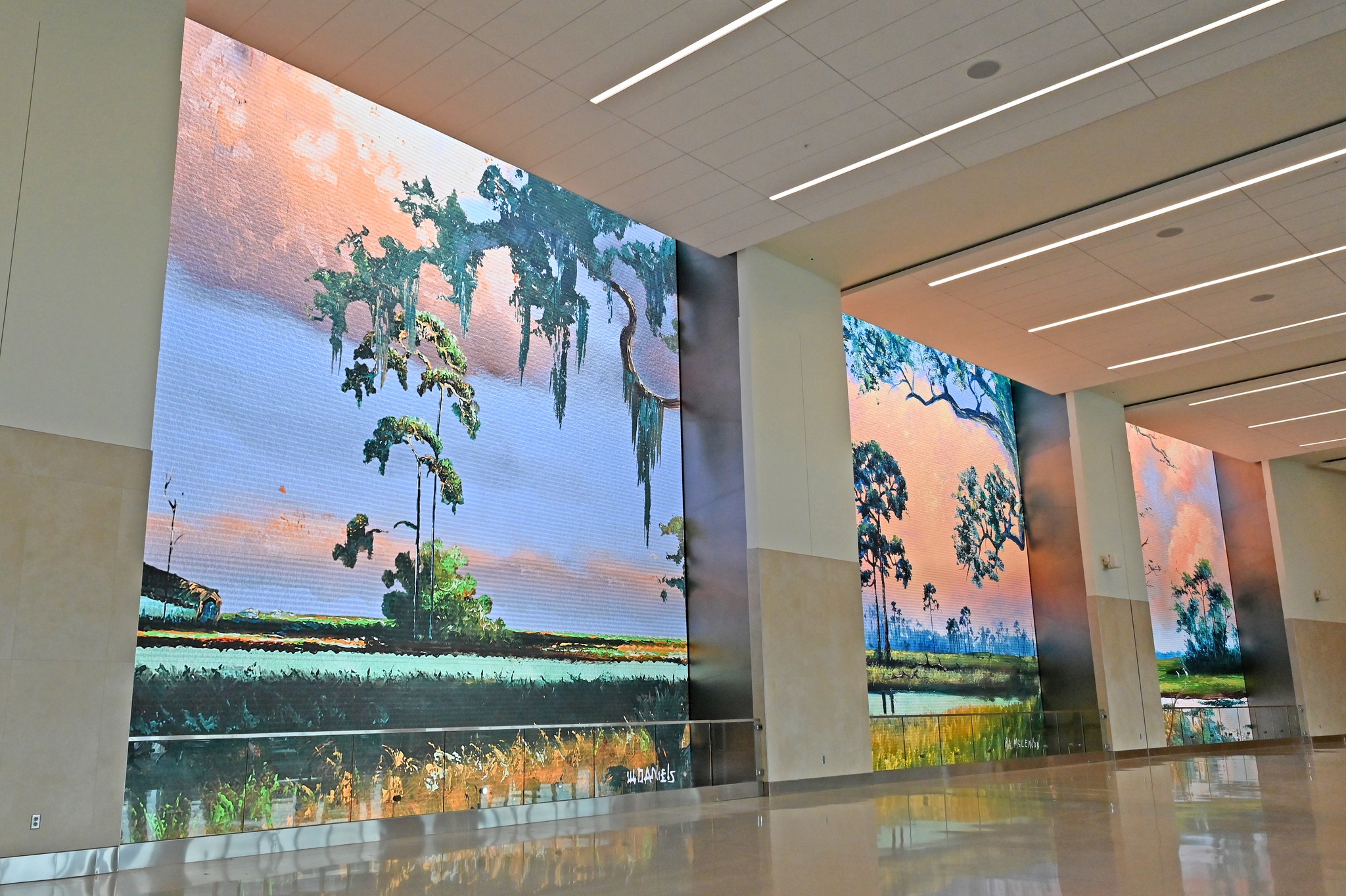 Orlando International Airport Terminal C Expansion Concourse with walls displaying Florida landscape art