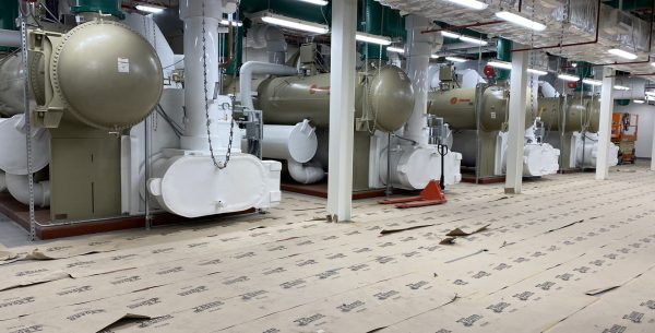 Row of large industrial chillers in a mechanical room at Orlando International Airport