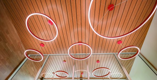 Indian Hill Bond Levy - Circular pendant lights hanging from a slatted wood ceiling