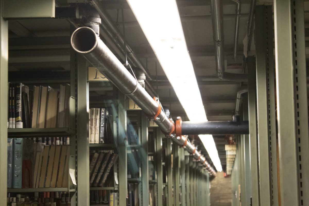MEP Engineering of overhead metal pipe running along library bookshelves at the Cincinnati Public Library