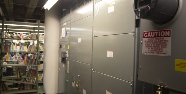 Electrical panels with a utility meter installed next to library book stacks for MEP Engineering at Cincinnati Public Library